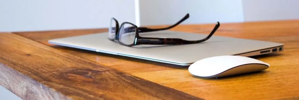 MacBook with glasses and Apple Mouse